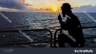 stock-photo-silhouette-people-offshore-crew-holding-walkie-talkie-to-communicate-with-his-partner-with-sunrise-560799805.jpg